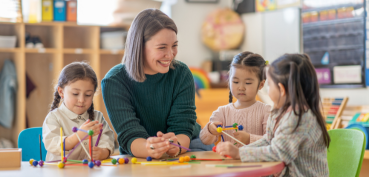 Image of teacher with young students